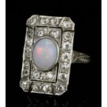 A 1920s platinum mounted opal and diamond ring, the rectangular face set with a central cabochon cut