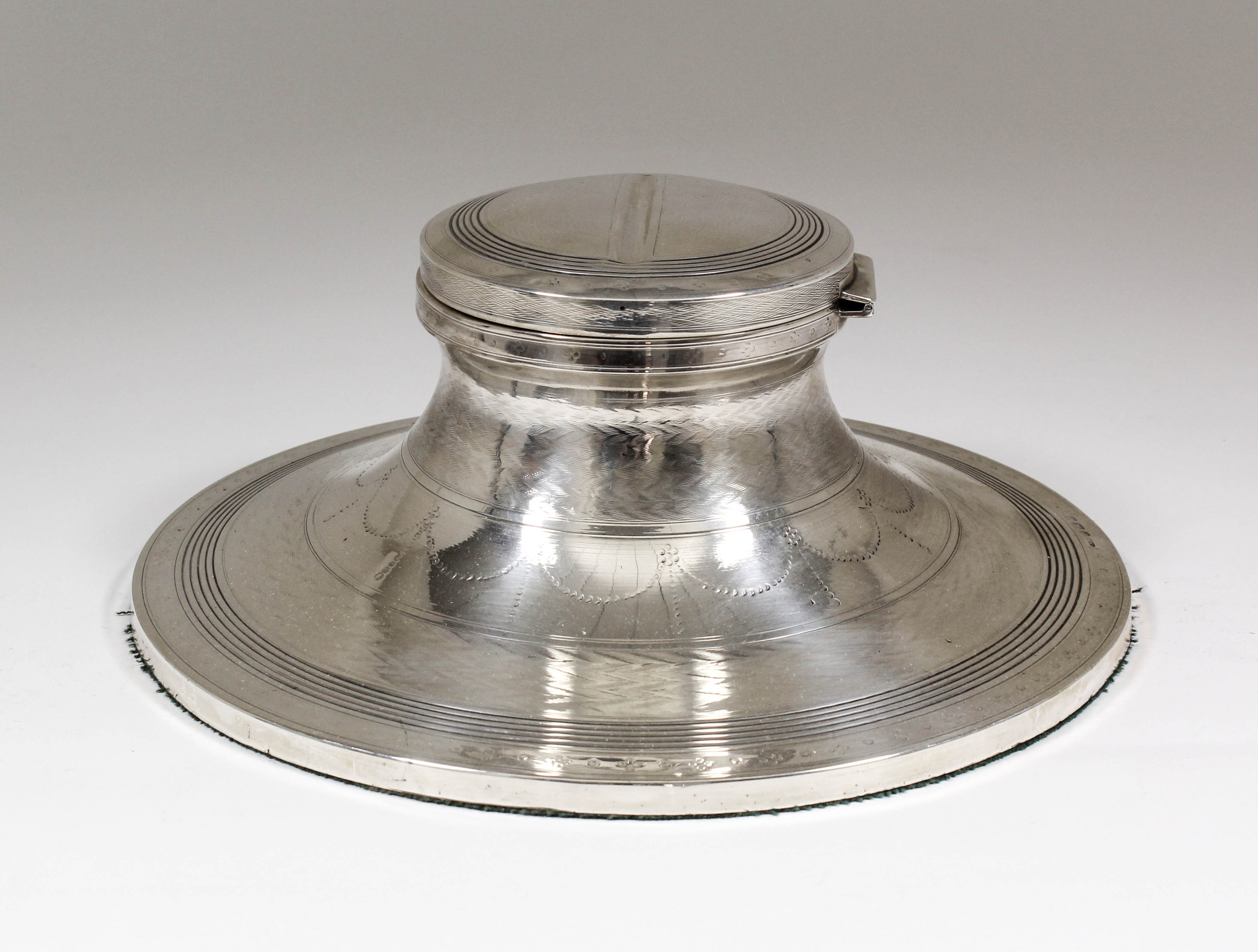 A large George V silver capstan pattern inkwell with reeded ornament, bands of engine turned