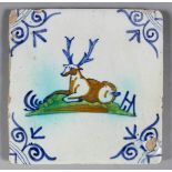 A rare 17th century Dutch maiolica polychrome tile with a recumbent stag within blue corners, 5.