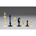 An 18th Century English black stained and plain turned ivory "Birds Nest" pattern chess set,