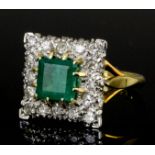 A modern 18ct gold mounted emerald and diamond ring, the square face set with a square cut emerald