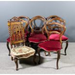 A set of four Victorian walnut balloon back dining room chairs with shaped and moulded backs and