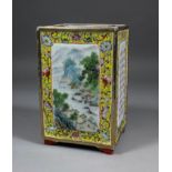 A Chinese porcelain rectangular vase with raised panels to all sides, the front and back enamelled