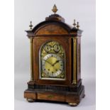 A late 19th Century German brass inlaid rosewood mantel clock, the arched brass dial with 7ins