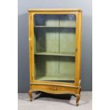 An early 20th Century yellow painted display cabinet in the French manner, with a concave front,