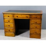 An oak kneehole desk of Victorian design, with moulded edge to top and insert with green leather,