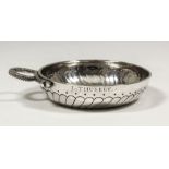 An 18th Century French silver circular taste-vin, the bowl engraved with spiral ribbed ornament