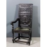 An old oak open armchair of "17th Century" design with moulded crest rail, the back carved with