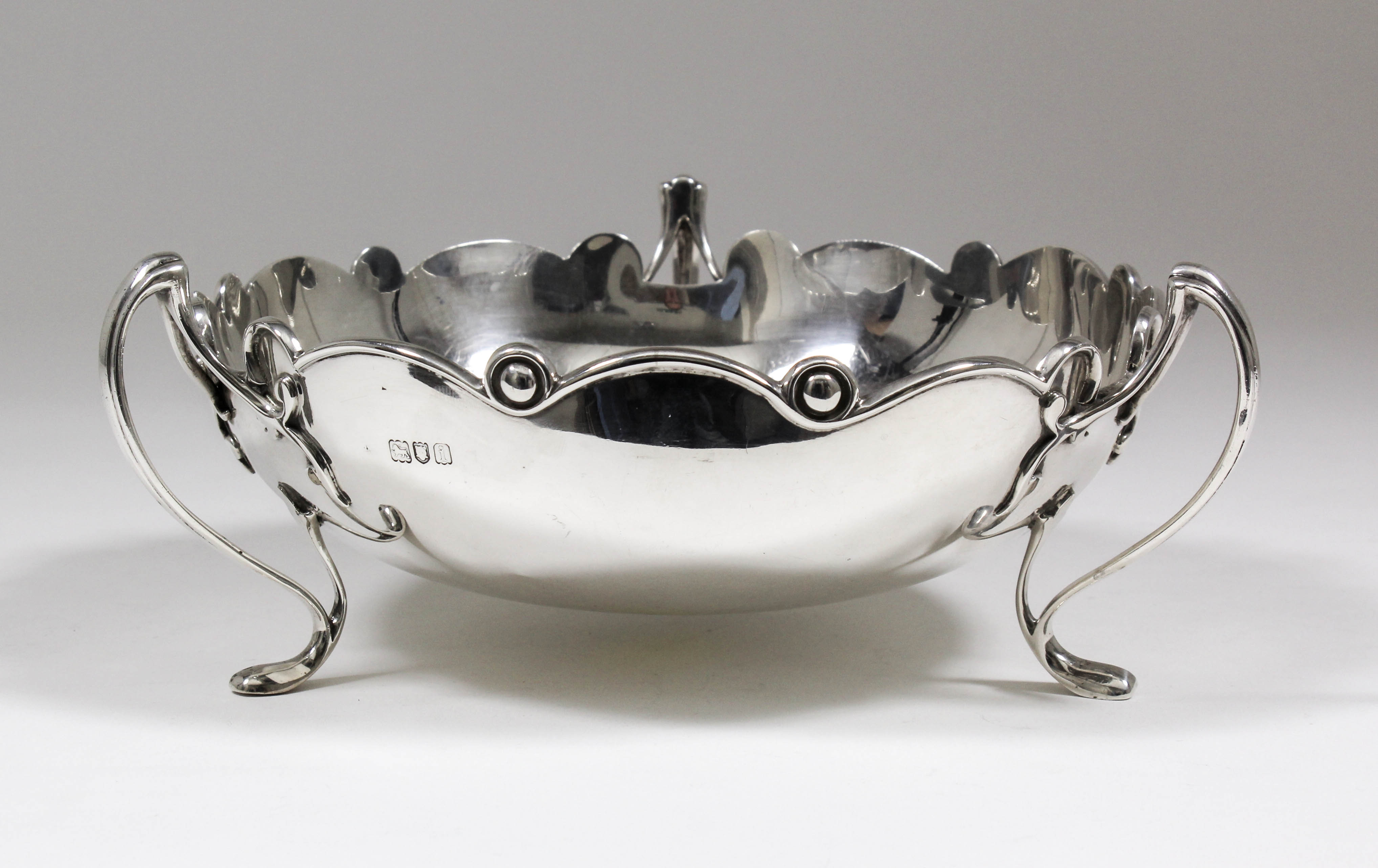 An Edward VII silver circular fruit bowl or centrepiece, the shallow bowl with shaped and moulded