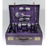 A George V lady's mauve leather dressing case, 18ins x 12.75ins x 7ins high, the mauve moire