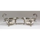 A pair of Elizabeth II silver sauce boats of large proportions with shaped rims, double C-scroll