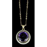 A modern gold coloured metal mounted amethyst and diamond set target pattern pendant, the 20mm