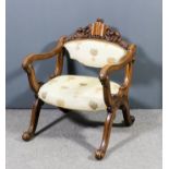 A Victorian walnut framed low back open armchair of shaped and scroll outline, the folding top