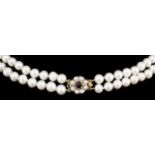 A modern two strand cultured pearl necklace with a circular 9ct gold seed pearl and garnet set
