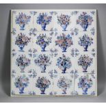 Sixteen 18th Century English polychrome Delft tiles painted in blue, green and red with flowers in a