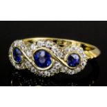 A modern 18ct gold mounted sapphire and diamond ring, the central circular cut sapphire .20ct and