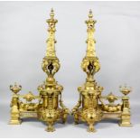 A pair of imposing late 19th Century French gilt brass chenet, each modelled in the form of a