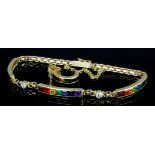 A modern 18ct gold bracelet, the three rectangular panels set with ruby, garnet, topaz, emerald,