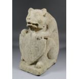 A 14th/15th Century English carved sandstone figure of a bear supporting a shield with Bend