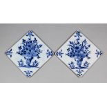 A pair of 18th Century English blue and white Delft tiles painted with flower vases with the rare