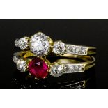 A modern 18ct gold mounted twin band ruby and diamond set ring, the central brilliant cut diamond (