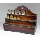 An 18th Century oak three tier spoon rack with shaped base and back, and five "Norwegian" silver