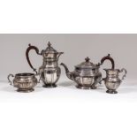 An Edward VII silver four piece tea service of circular form with moulded rims, leaf cast girdles,