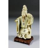 A Japanese carved ivory standing figure of an actor from the Classical Opera, his costume inlaid