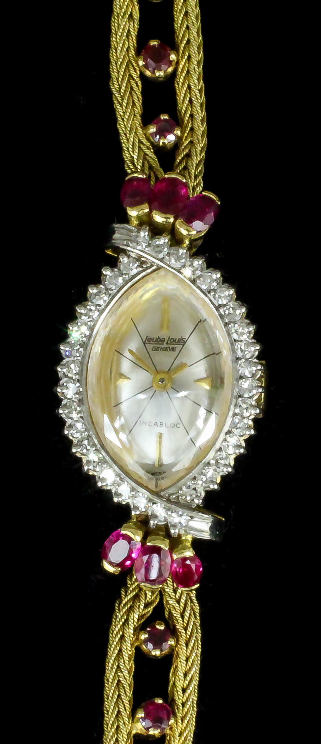 A modern lady's Leuba Louis 18ct gold mounted ruby and diamond set cocktail watch, the ovoid face