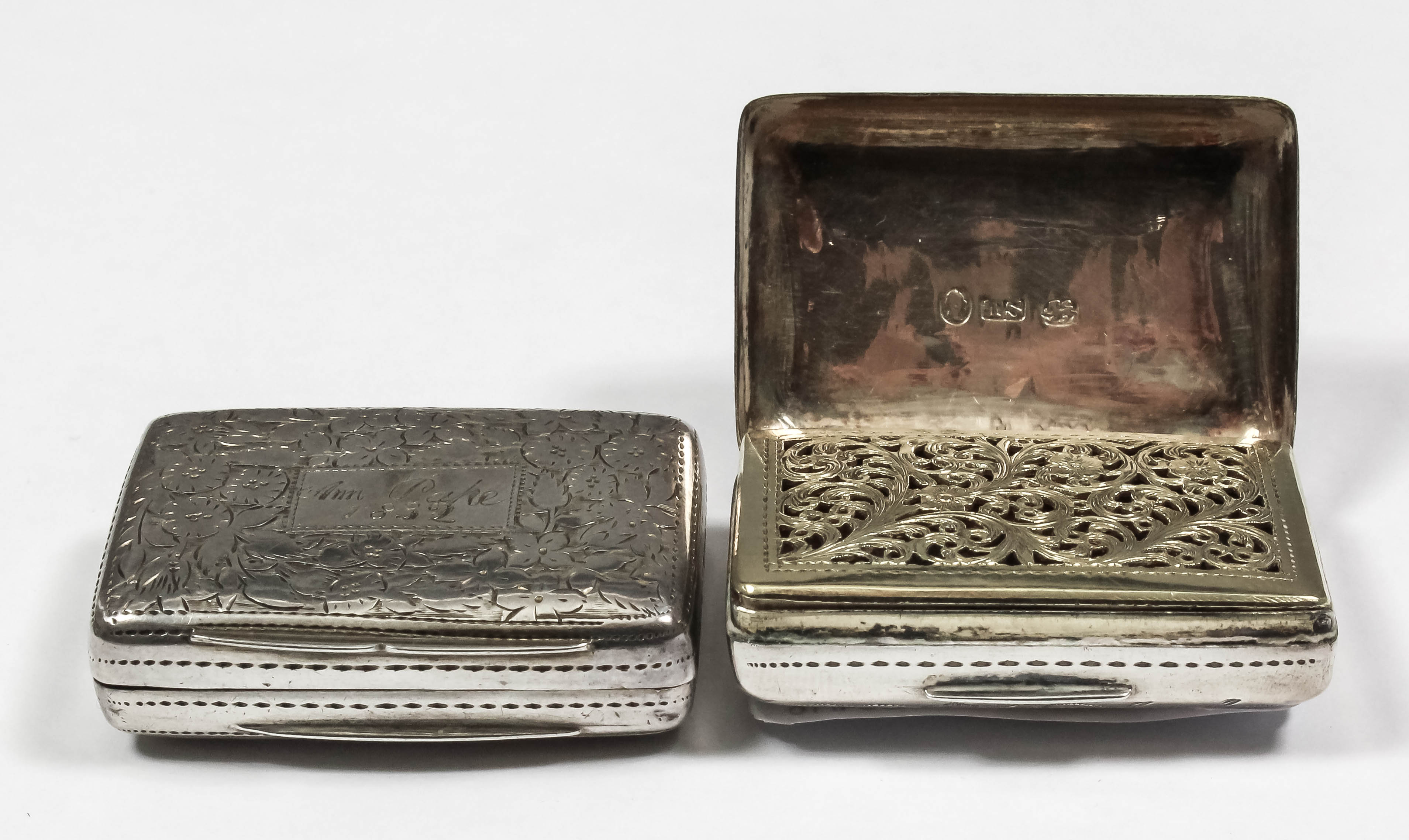 Two William IV silver rectangular vinaigrettes, each with lid and base engraved with leaf and floral