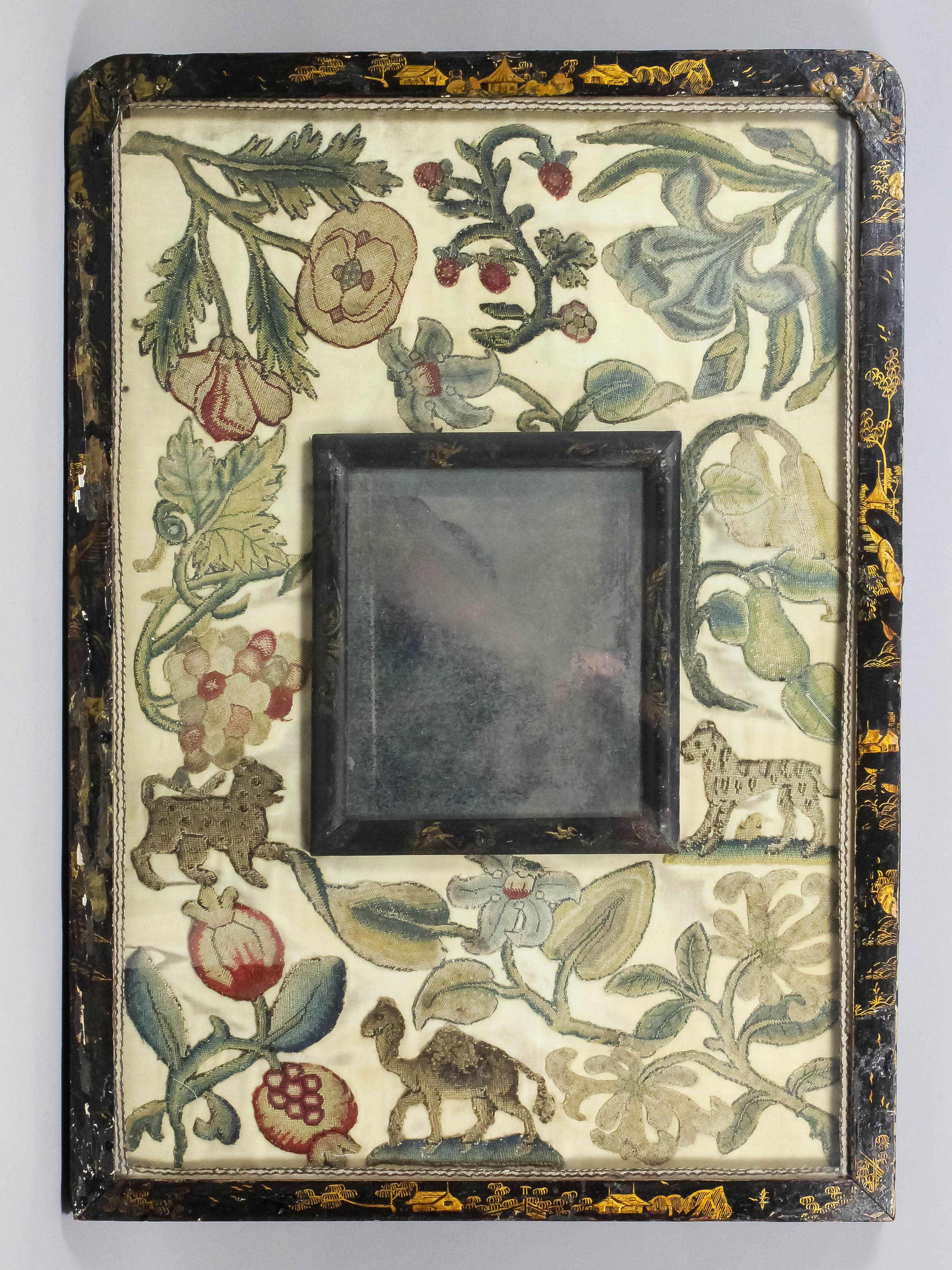 A late 17th Century wall mirror in a black and gilt japanned frame, with a broad surround of