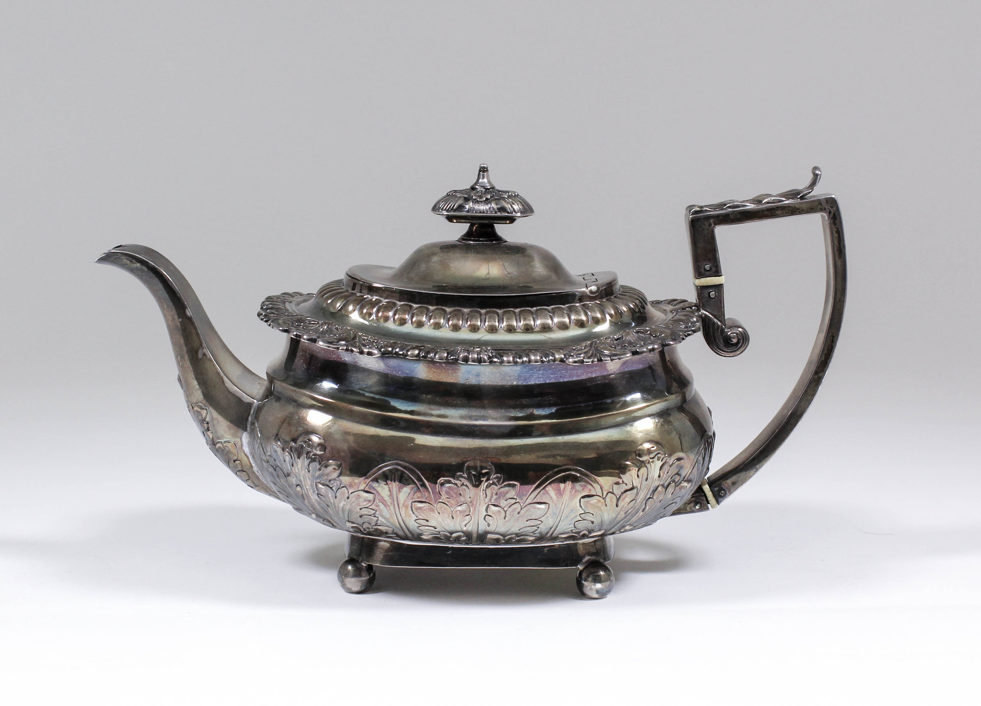 A George III silver rectangular teapot, the slightly domed cover with rectangular leaf pattern