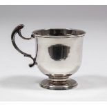 A George II plain silver urn shaped tot or mug with open double scroll handle and moulded rim and