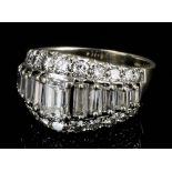 A modern 18ct white gold mounted all diamond set ring, the face set with ten graduated baguette