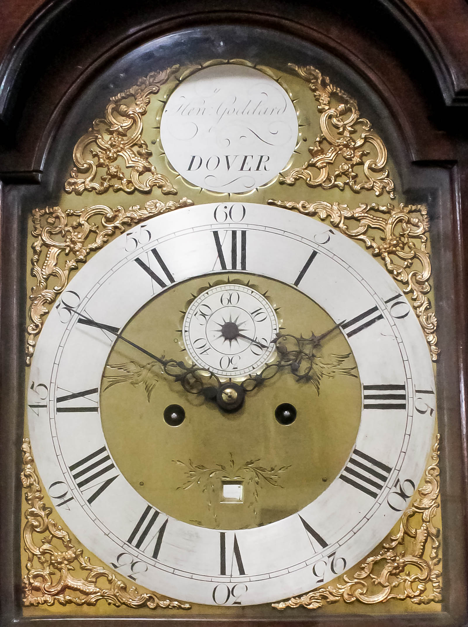 A late 18th Century mahogany longcase clock by Henry Goddard of Dover, the 12ins arched brass dial