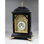 A late 19th Century French ebonised mantel clock, the arched dial with 2.5ins diameter enamelled