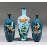 A pair of Japanese cloisonne enamel baluster shaped vases decorated with pigeons on a blue ground,