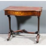 A Victorian walnut writing table of serpentine outline with leather inset to top, fitted one