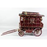 A painted model of a Gypsy caravan, 19ins x 10ins x 17ins high, complete with some contents