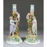 A pair of late 19th Century Continental porcelain figural candlesticks modelled as young ladies