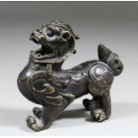 A Chinese bronze model of a standing kylin, his mouth open with head thrown back, 3.75ins (95mm)