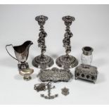 A pair of plated pillar candlesticks, the columns cast in the form of lightly draped putti, on