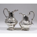 Two Victorian silver bulbous milk jugs with shaped rims and double scroll handle, one with low