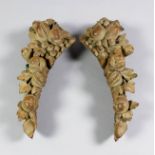 A pair of carved wood ornaments carved with berries and leaves, 24ins high x 4ins wide, and a blue