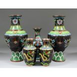 A pair of early 20th Century Chinese baluster shaped enamel vases decorated with two dragons chasing