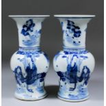 A pair of Chinese blue and white porcelain Yen-Yen vases painted with figures in a fenced garden