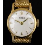 A modern lady's 18ct gold Rolex wristwatch, the white dial with baton numerals, contained in plain