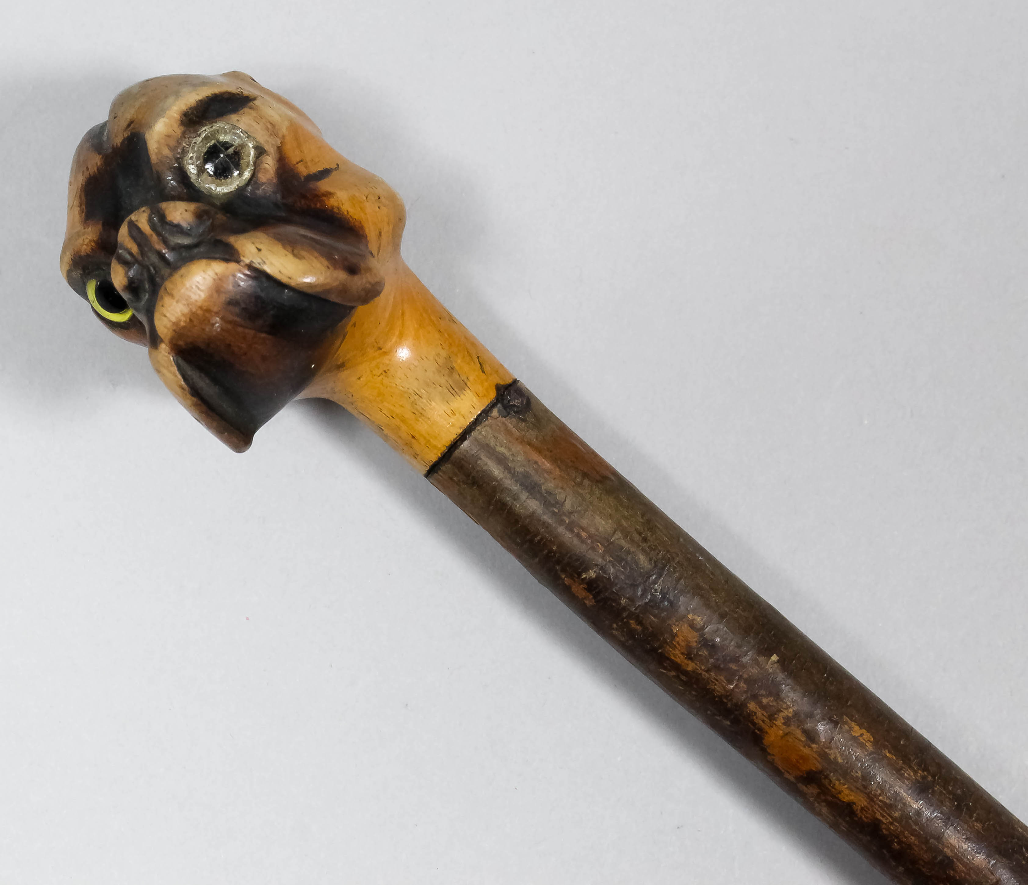 A stained wood walking cane with carved wood handle in the form of the head of a Boxer dog, 35ins