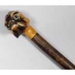 A stained wood walking cane with carved wood handle in the form of the head of a Boxer dog, 35ins