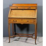 An Edwardian satinwood bureau, inlaid with rosewood crossbandings and ebonised stringings, fitted